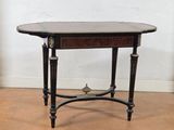 a small table with a black top on a wooden floor