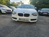 une BMW blanche garée sur un parking