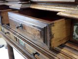 a wooden dresser with a mirror on top of it