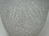 a close up of a glass vase on a table