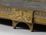 a gold bed with a metal frame on it
