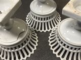 several white dishes are stacked on top of each other on a table