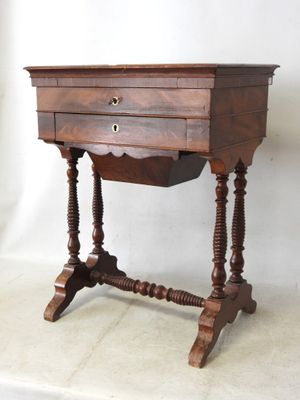 a small wooden table with a drawer on top of it