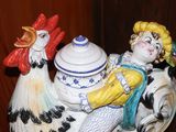 a figurine of a rooster and a chicken on a table