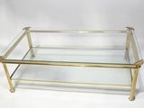 a glass and brass coffee table with a glass top