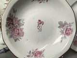 two plates and a bowl sitting on a table