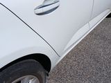 a white car that is parked on the side of the road