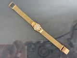 a close up of a gold watch on a table