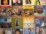 a wall covered with many different album covers on it