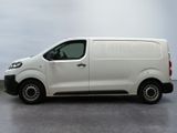 the white van is parked in a parking lot on a cloudy day