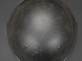 a close up of a helmet on a table with a black background