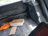 a box of carrots in the back of a car