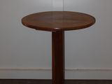 a small table with a wooden base in a room