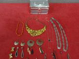 an assortment of jewelry is displayed on a red surface