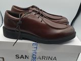 brown leather shoes with laces on top of a box