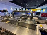 stainless steel counter top in a restaurant with beer taps on it