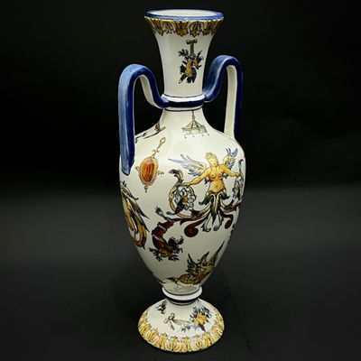 a vase with a blue handle on a black background