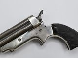 a close up of a revolver on a white surface