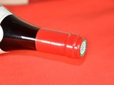 a bottle of wine on a table with a red cloth