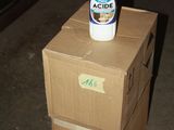 boxes stacked on top of each other with a bottle on top of them