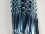 a close up of a bunch of metal blades on a white surface