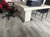 a desk with a computer and a chair in the room