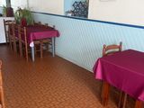 tables and chairs in a restaurant with pink tablecloths on them