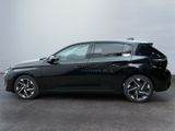 the black car is parked on the concrete floor in the room
