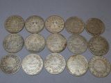 some silver coins are sitting on a table with a blue background