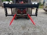 a picture of a forklift with two red forks attached to it