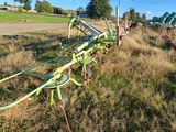 a row of lawn chairs in the middle of a field