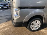 a silver van that is parked in a parking lot