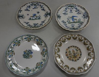 three plates with blue and green designs on them on a table