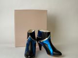 pair of black and blue high heeled boots with a box in the background