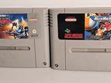 two nintendo game cartridges sitting next to each other on a table