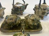 five pieces of pottery sitting on a table
