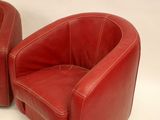 pair of red leather lounge chairs on white background