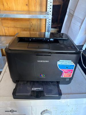 a black printer sitting on top of a washing machine