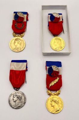 several medals are displayed in a white box on a table