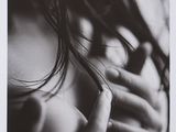black and white photograph of a woman with her hands on her chest