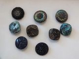 several different types of buttons are arranged on a white surface