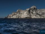 a large rock out in the middle of the ocean