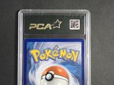 the pokemon card is in a plastic holder on a table