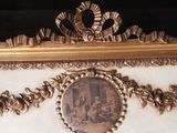 a gold frame with a picture of a man and a woman on it