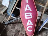 a sign that says tabac on it on a brick floor