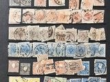 an image of a collection of stamps on display in a black frame