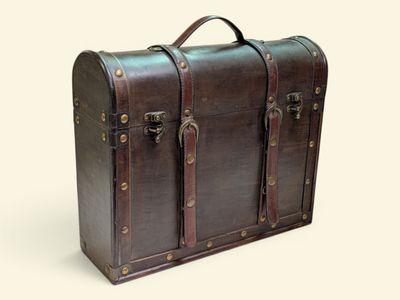 a brown leather suitcase with two handles on a white background