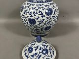 vase bleu et blanc avec un motif floral sur le socle