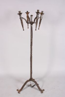 an image of a metal candelab with four candles on a stand