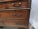 a wooden chest of drawers with brass handles on it